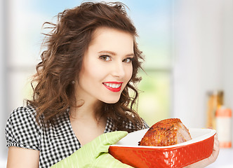 Image showing housewife serving dish with meat