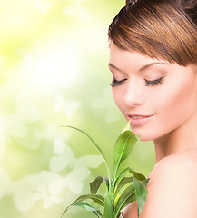 Image showing woman with sprout and butterflies