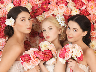 Image showing three women with background full of roses