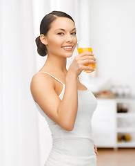 Image showing woman with glass of juice at kitchen