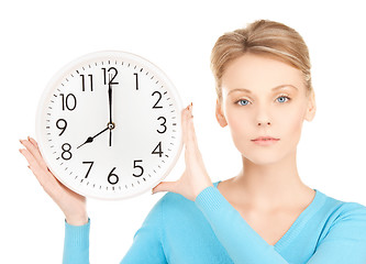 Image showing businesswoman with wall clock