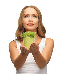 Image showing woman with green grass in pot