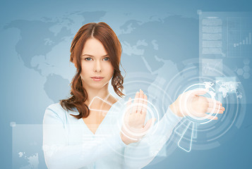 Image showing businesswoman touching virtual screen