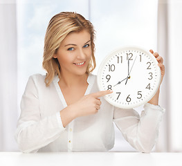 Image showing woman with clock