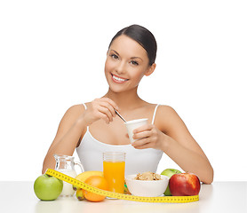 Image showing woman with healthy breakfast and measuring tape