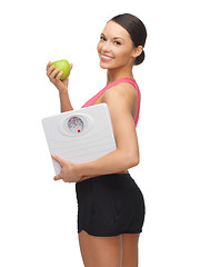 Image showing woman with apple and weight scale