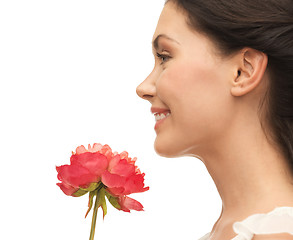 Image showing smiling woman smelling flower