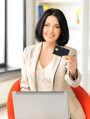 Image showing businesswoman with laptop showing credit card