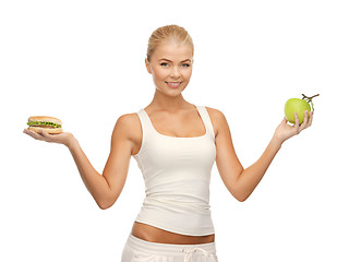 Image showing woman with apple and hamburger