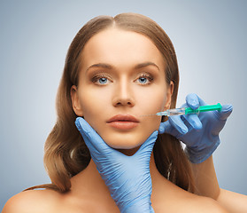 Image showing woman face and beautician hands