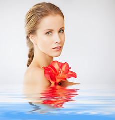 Image showing lovely woman with lily flower in water