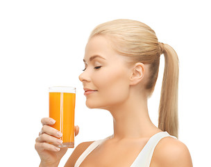 Image showing young woman drinking orange juice