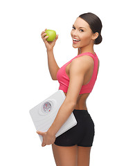 Image showing sporty woman with scale and green apple