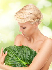 Image showing woman with green leaf and butterflies