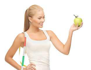 Image showing sporty woman with apple and measuring tape