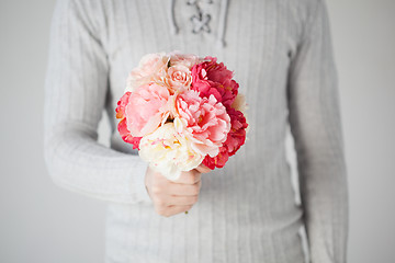 Image showing man holding bouquet of flowers