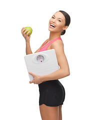 Image showing sporty woman with scale and green apple