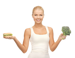 Image showing woman with broccoli and hamburger