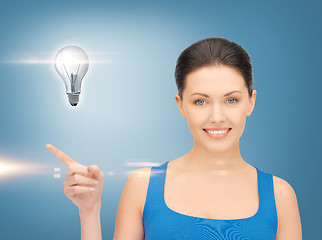 Image showing woman showing light bulb on her hand