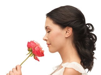 Image showing smiling woman smelling flower