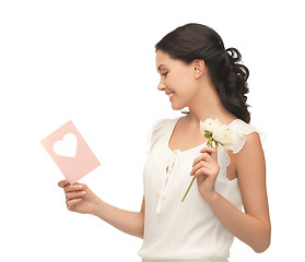 Image showing young woman holding flower and postcard