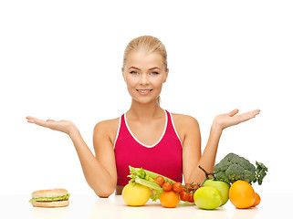 Image showing woman with fruits and hamburger