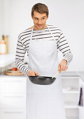 Image showing handsome man with pan at kitchen