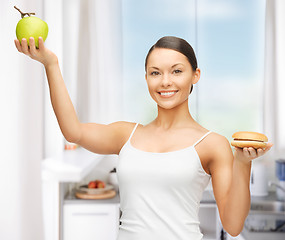 Image showing woman with hamburger and apple