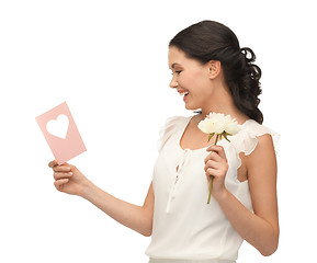 Image showing young woman holding flower and postcard