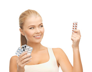 Image showing young woman with pills