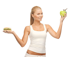 Image showing woman with apple and hamburger