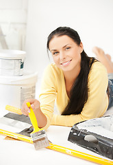 Image showing woman with paintbrush and renovating tools