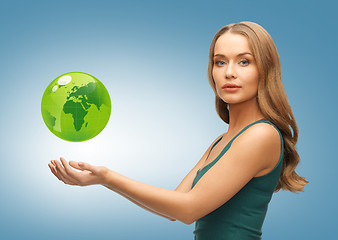 Image showing woman holding green globe on her hands