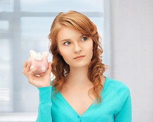 Image showing teenage girl with piggy bank