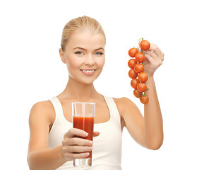 Image showing woman holding glass of juice and tomatoes