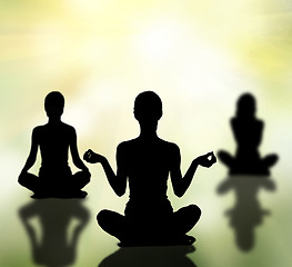 Image showing silhouettes of women practicing yoga lotus pose