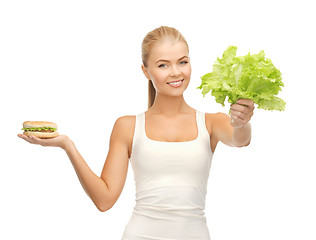 Image showing woman with green leaves and hamburger