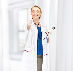 Image showing attractive female doctor pointing her finger