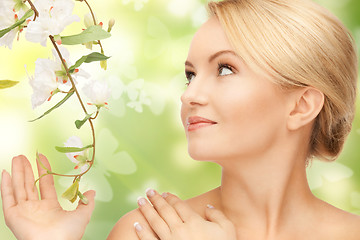 Image showing woman with flowers on twig and butterflies