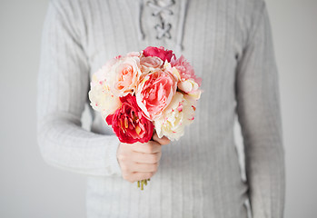 Image showing man holding bouquet of flowers