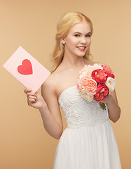 Image showing young woman holding flower and postcard