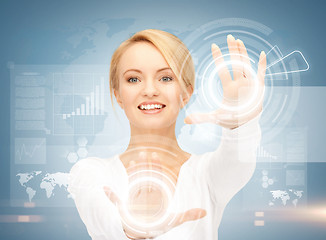 Image showing businesswoman touching virtual screen