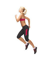 Image showing sporty woman running or jumping