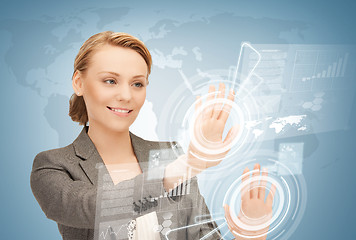 Image showing businesswoman touching virtual screen