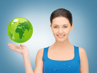 Image showing woman holding green globe on her hand