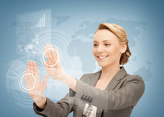 Image showing businesswoman touching virtual screen