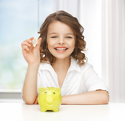 Image showing girl with piggy bank