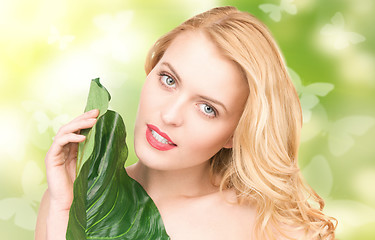 Image showing woman with green leaf and butterflies