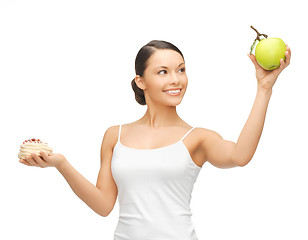 Image showing sporty woman with apple and cake