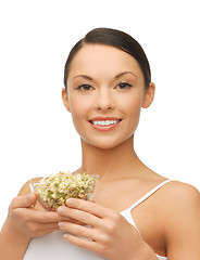 Image showing healthy woman holding bowl with sprout